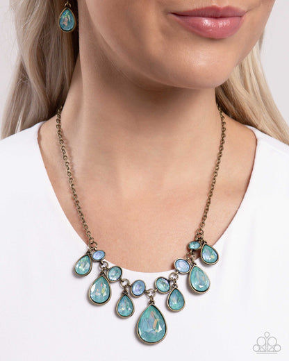 Talented Teardrops - Brass & Blue Zircon UV Gem Necklace - Paparazzi Accessories