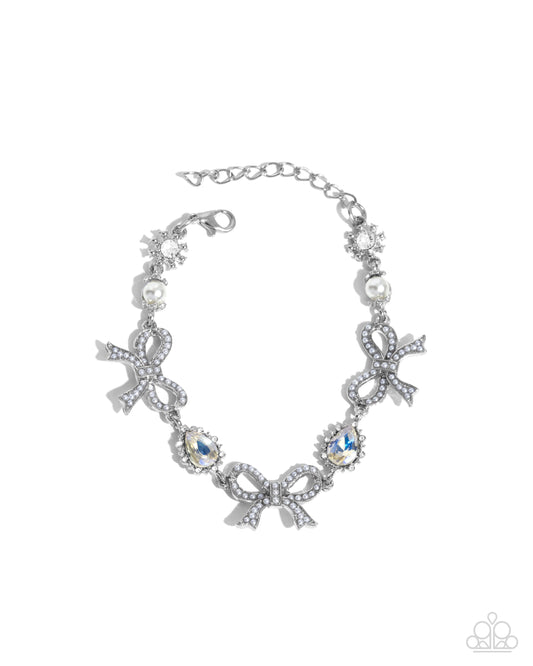 Coquette Caliber - White Pearl Bow Iridescent Rhinestone Silver Clasp Bracelet - Paparazzi Accessories